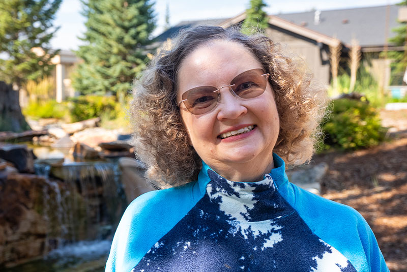headshot of patient smiling brightly after their dental procedure treatment