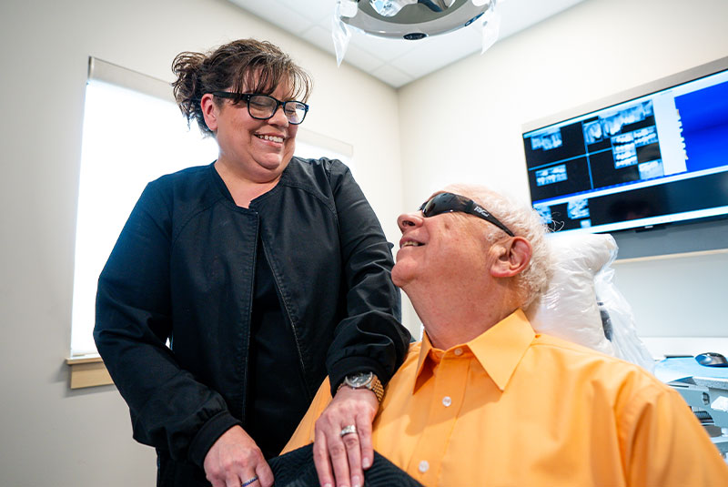 patient and doctor both smiling brightly prep and ready for dental procedure
