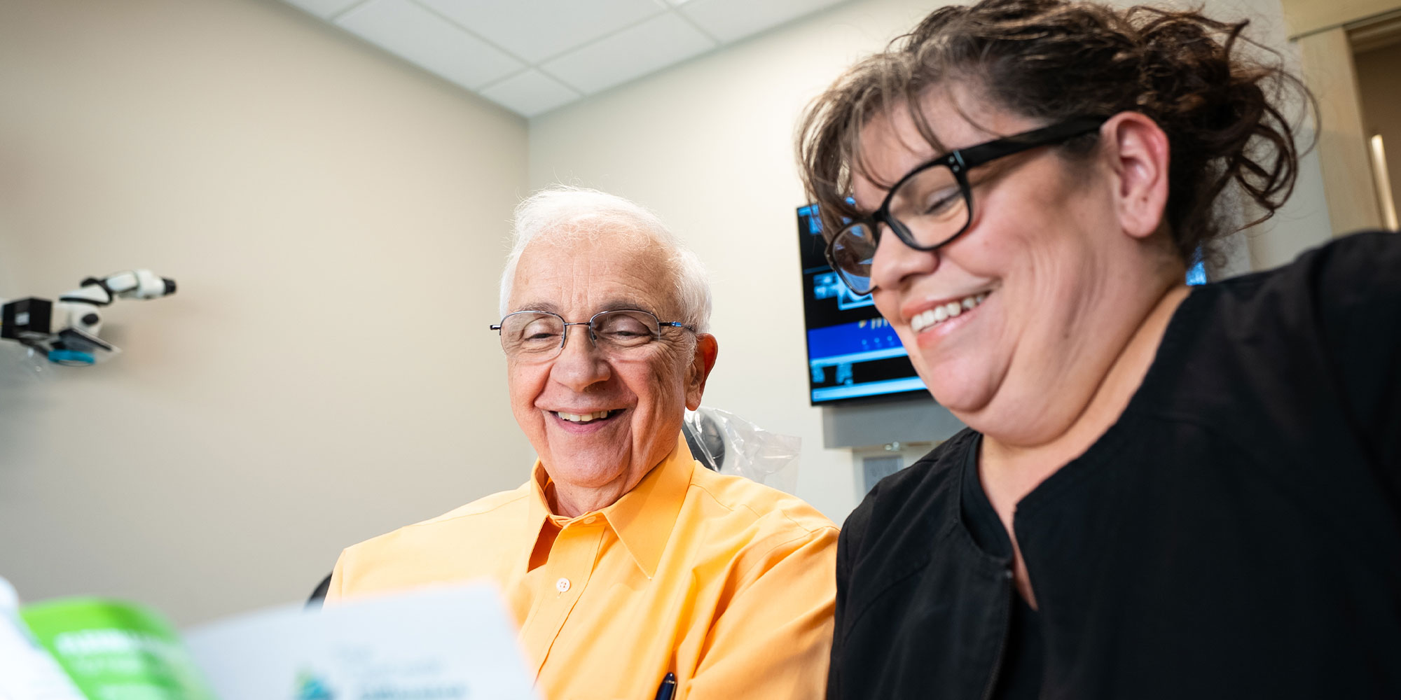 denta patient and staff member going over dental finance information